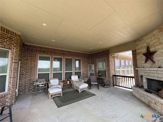 view of patio featuring an outdoor stone fireplace