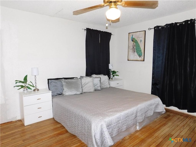 bedroom featuring ceiling fan and light hardwood / wood-style floors