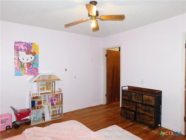 bedroom featuring dark hardwood / wood-style floors and ceiling fan