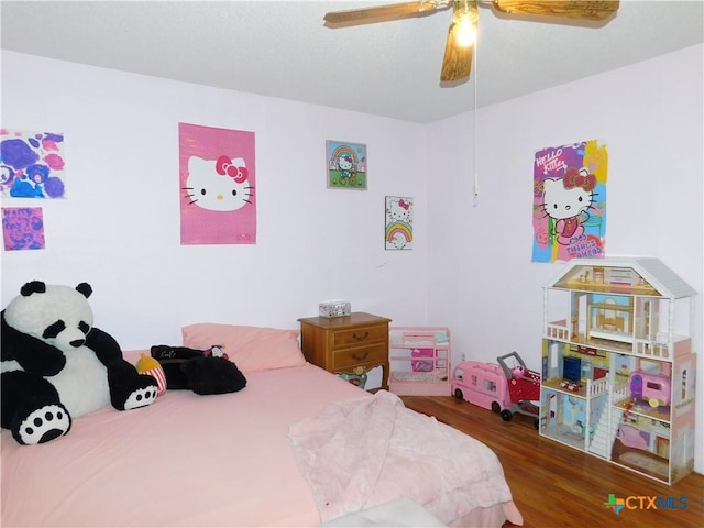 bedroom featuring ceiling fan and dark hardwood / wood-style floors