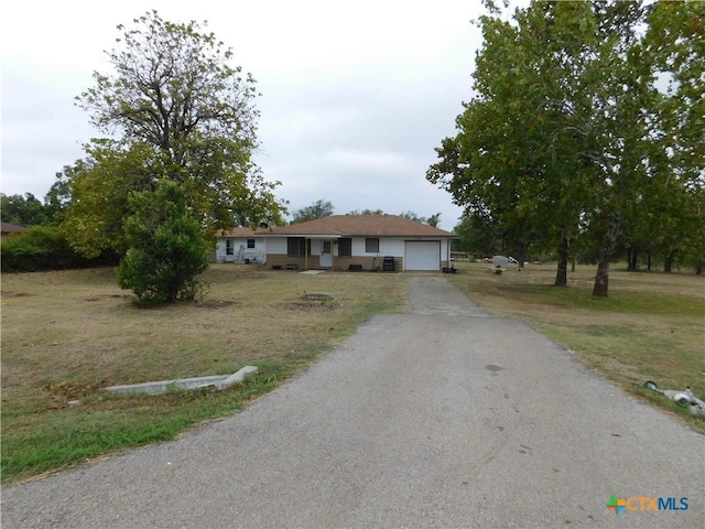 single story home with a front lawn and a garage