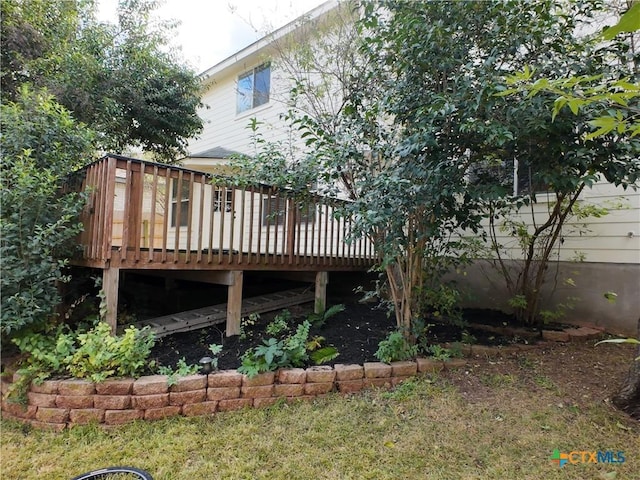 rear view of property featuring a wooden deck