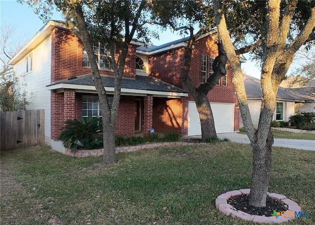 view of property with a garage and a front lawn