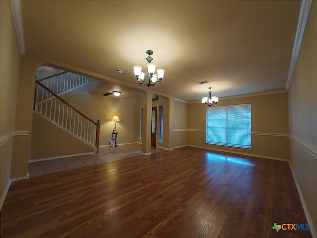 unfurnished living room featuring wood-type flooring, ornamental molding, and a chandelier