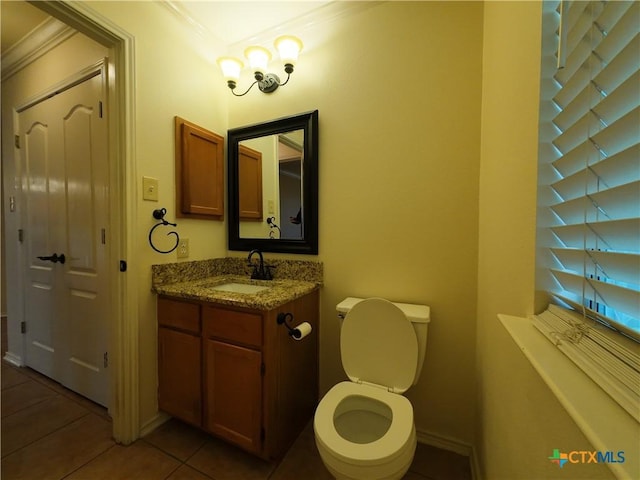 bathroom with tile patterned flooring, vanity, toilet, and ornamental molding