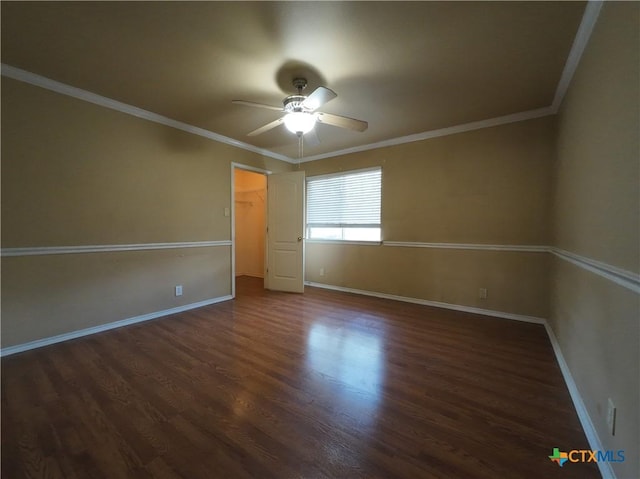 empty room with ceiling fan, dark hardwood / wood-style floors, and ornamental molding