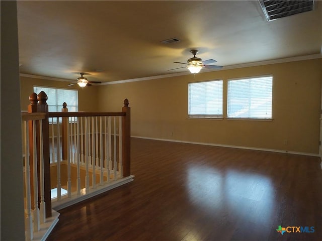 empty room with dark hardwood / wood-style flooring and ornamental molding