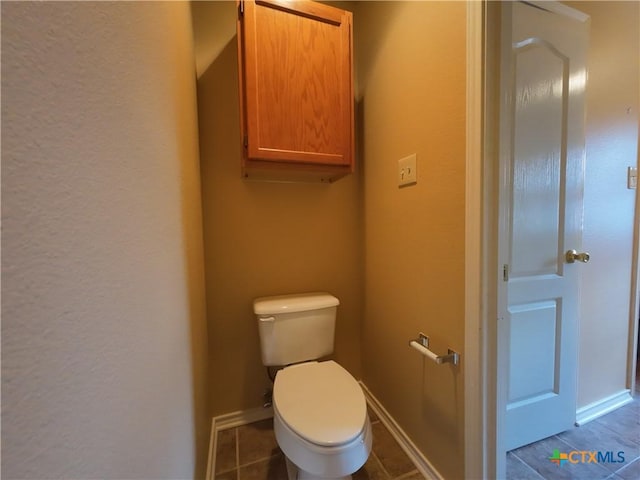 bathroom featuring tile patterned flooring and toilet