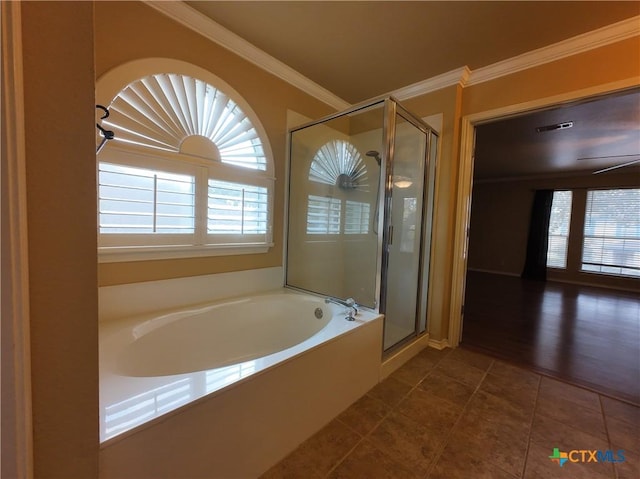 bathroom featuring plenty of natural light, independent shower and bath, and ornamental molding