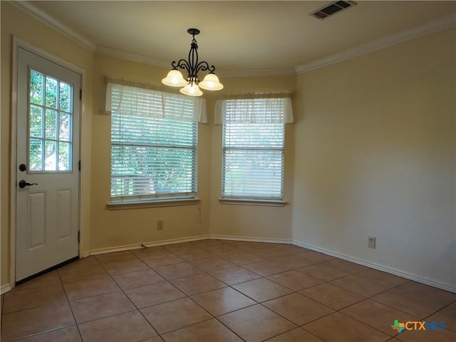 unfurnished dining area with a healthy amount of sunlight, light tile patterned floors, ornamental molding, and an inviting chandelier