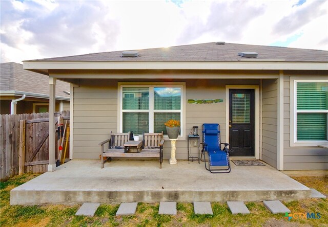 back of property with a patio