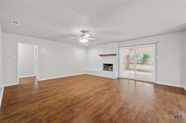 906 Laurie Ln, Copperas Cove, TX 76522 - unfurnished living room with a ceiling fan, wood finished floors, a textured ceiling, and a fireplace