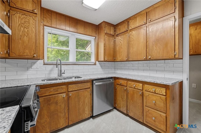906 Laurie Ln, Copperas Cove, TX 76522 - kitchen featuring stainless steel appliances, brown cabinets, backsplash, a textured ceiling, and light stone countertops