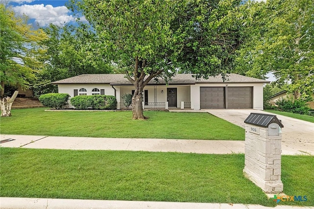 906 Laurie Ln, Copperas Cove, TX 76522 - ranch-style home with a garage, driveway, a front lawn, covered porch, and stucco siding