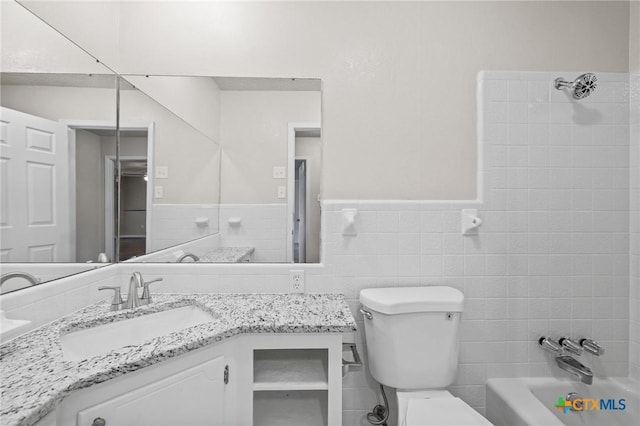906 Laurie Ln, Copperas Cove, TX 76522 - bathroom featuring tile walls, vanity, wainscoting, and shower / bathtub combination
