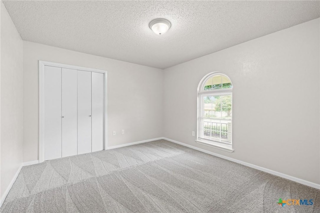 906 Laurie Ln, Copperas Cove, TX 76522 - unfurnished bedroom featuring carpet, a textured ceiling, and a closet