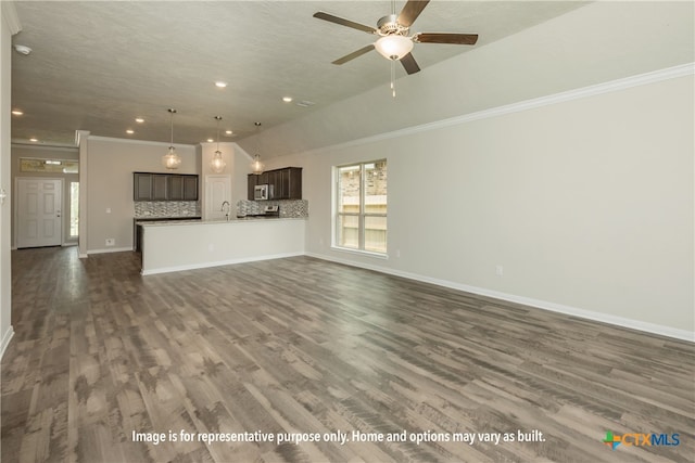 unfurnished living room featuring dark wood-type flooring, a textured ceiling, and crown molding