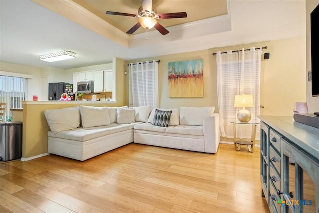 216 Pullman Place Blvd, Temple, TX 76502 - living room with a raised ceiling, light wood-style flooring, wine cooler, a ceiling fan, and crown molding