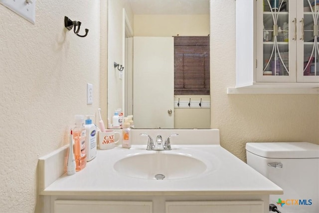 216 Pullman Place Blvd, Temple, TX 76502 - bathroom featuring a textured wall, vanity, and toilet