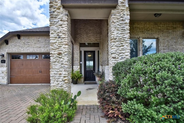 1812 Gibraltar Dr, San Marcos, TX 78666 - property entrance featuring brick siding, a garage, and driveway