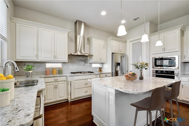 1812 Gibraltar Dr, San Marcos, TX 78666 - kitchen with appliances with stainless steel finishes, wall chimney exhaust hood, a sink, backsplash, and white cabinets