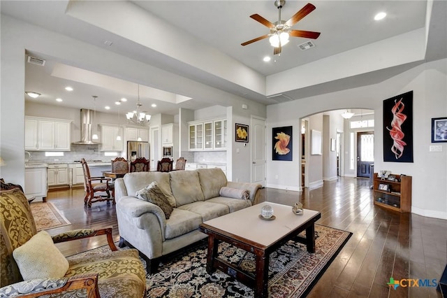 1812 Gibraltar Dr, San Marcos, TX 78666 - living area with arched walkways, ceiling fan, baseboards, a chandelier, and a raised ceiling