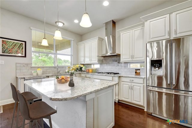 1812 Gibraltar Dr, San Marcos, TX 78666 - kitchen featuring appliances with stainless steel finishes, wall chimney range hood, white cabinets, dark wood-style floors, and recessed lighting
