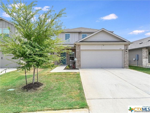 view of front of property featuring a garage and a front lawn