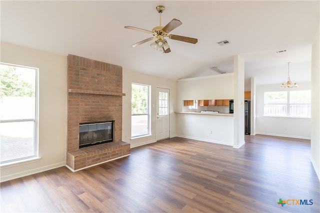 unfurnished living room with a wealth of natural light and dark wood-type flooring