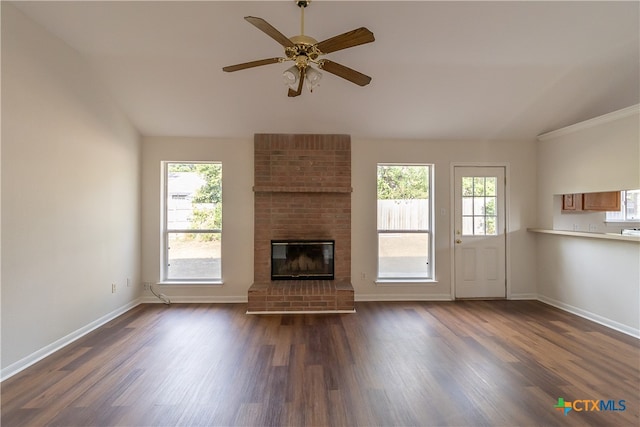 unfurnished living room with ceiling fan, a healthy amount of sunlight, and dark hardwood / wood-style floors