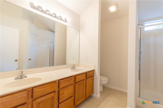 bathroom with toilet, vanity, tile patterned floors, and a shower with door