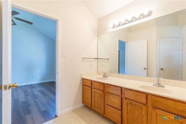 bathroom featuring wood-type flooring, ceiling fan, vaulted ceiling, and vanity