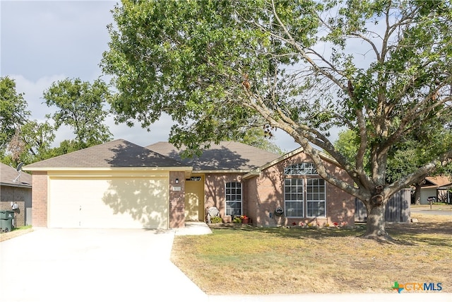 ranch-style home with a garage and a front lawn