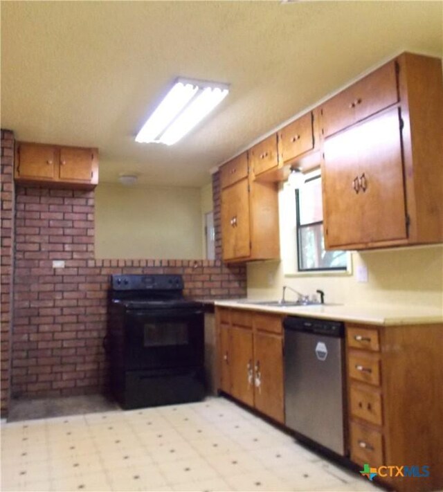 765 Benchmark Trl, Belton, TX 76513 - kitchen with black electric range oven, stainless steel dishwasher, a sink, brown cabinetry, and brick wall