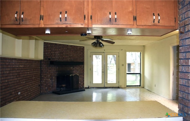 765 Benchmark Trl, Belton, TX 76513 - unfurnished living room with brick wall, light floors, ceiling fan, and a brick fireplace