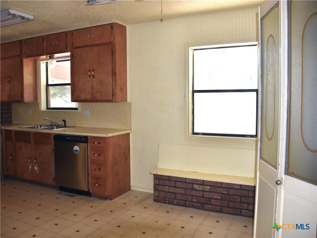 765 Benchmark Trl, Belton, TX 76513 - kitchen with stainless steel dishwasher, light flooring, a sink, and brown cabinets