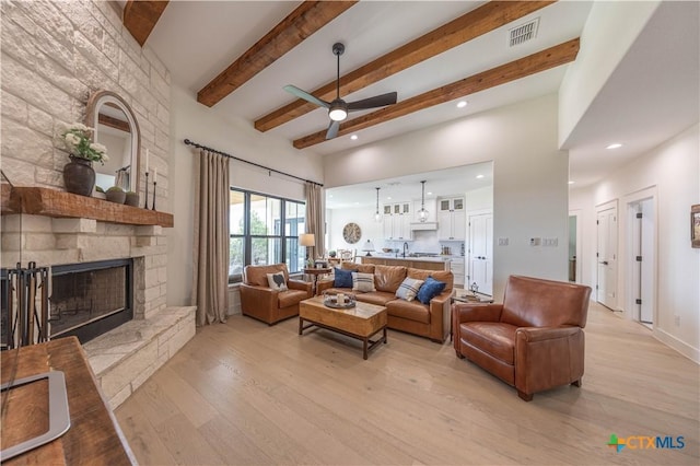 150 Panorama Dr, Wimberley, TX 78676 - living area featuring ceiling fan, light wood finished floors, a stone fireplace, beam ceiling, and recessed lighting