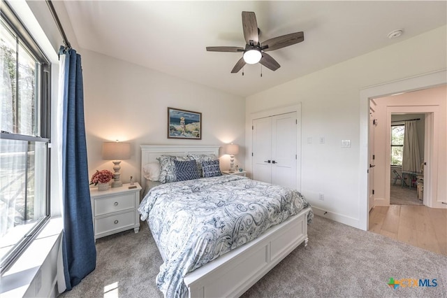 150 Panorama Dr, Wimberley, TX 78676 - bedroom featuring light carpet, a closet, and a ceiling fan