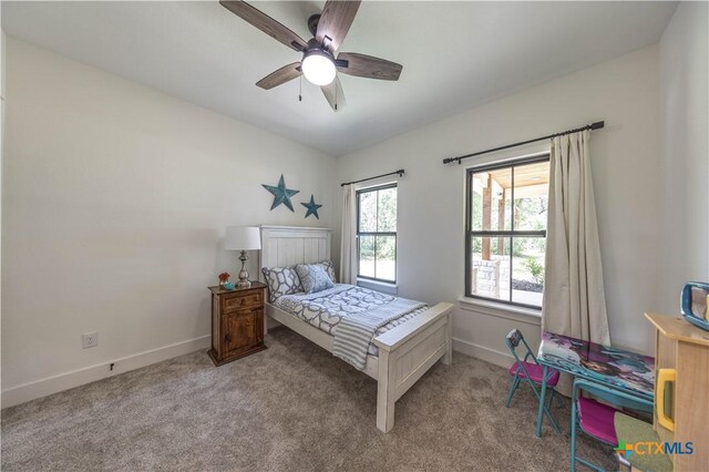 150 Panorama Dr, Wimberley, TX 78676 - carpeted bedroom featuring baseboards and a ceiling fan