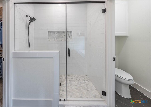 150 Panorama Dr, Wimberley, TX 78676 - full bathroom featuring a stall shower, tile patterned flooring, and a walk in closet