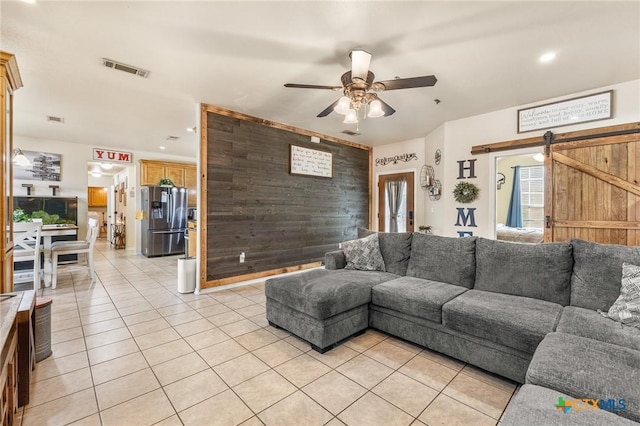 846 Thomas St, Copperas Cove, TX 76522 - living room with a ceiling fan, light tile patterned flooring, wooden walls, recessed lighting, and an accent wall
