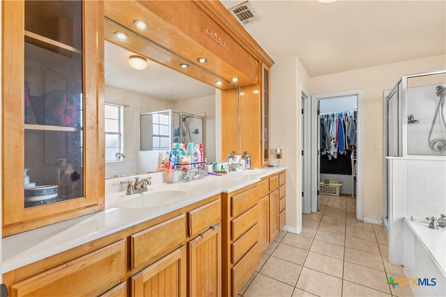 846 Thomas St, Copperas Cove, TX 76522 - bathroom featuring a shower stall, tile patterned flooring, double vanity, a walk in closet, and a bathtub