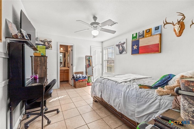846 Thomas St, Copperas Cove, TX 76522 - bedroom with light tile patterned flooring, a ceiling fan, and ensuite bath