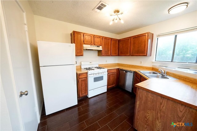 kitchen featuring a sink, visible vents, white appliances, under cabinet range hood, and light countertops