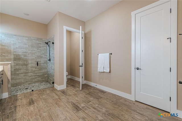 bathroom with vanity, toilet, and a shower with shower door