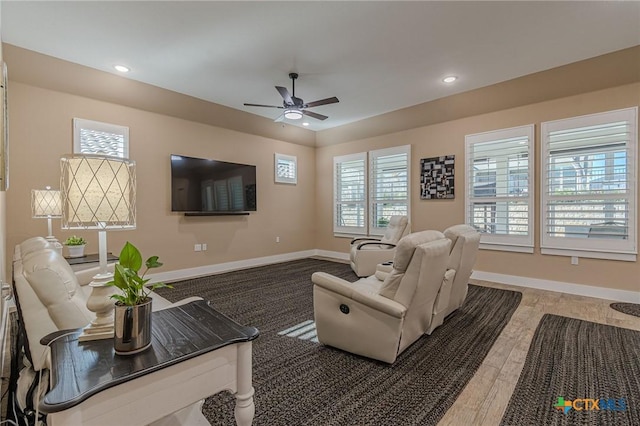 living room featuring wood-type flooring and ceiling fan