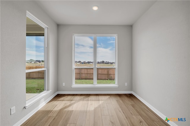 unfurnished room with light hardwood / wood-style floors