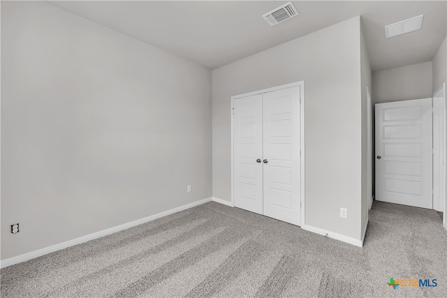 unfurnished bedroom with carpet and a closet