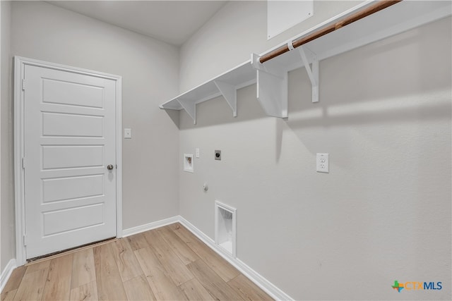 laundry area featuring light hardwood / wood-style floors, hookup for a gas dryer, electric dryer hookup, and washer hookup