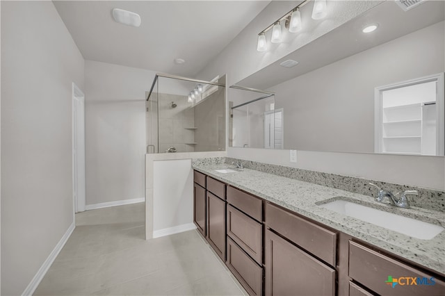 bathroom featuring tile patterned flooring, vanity, and an enclosed shower